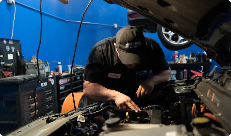 Auto Air Conditioning Repair In Rancho Santa Margarita, CA At Bobby Grich Auto Repair. Mechanic performing car AC repair in auto repair shop