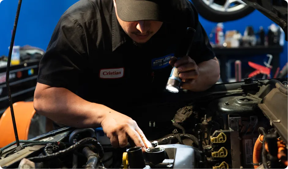 Vehicle Inspections In Rancho Santa Margarita, CA At Bobby Grich Auto Repair Mechanic performing a car vehicle inspection in auto repair shop.