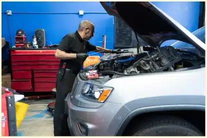 Vehicle Maintenance in Rancho Santa Margarita, CA At Bobby Grich Auto Repair. Mechanic inspection the vehicle engine for maintenance