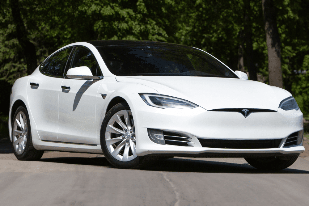 Tesla maintenance in Rancho Santa Margarita by Bobby Grich Auto Repair. Image of a white Tesla sedan parked outdoors, highlighting clean exterior condition and professional care focused on performance, safety, and routine maintenance.