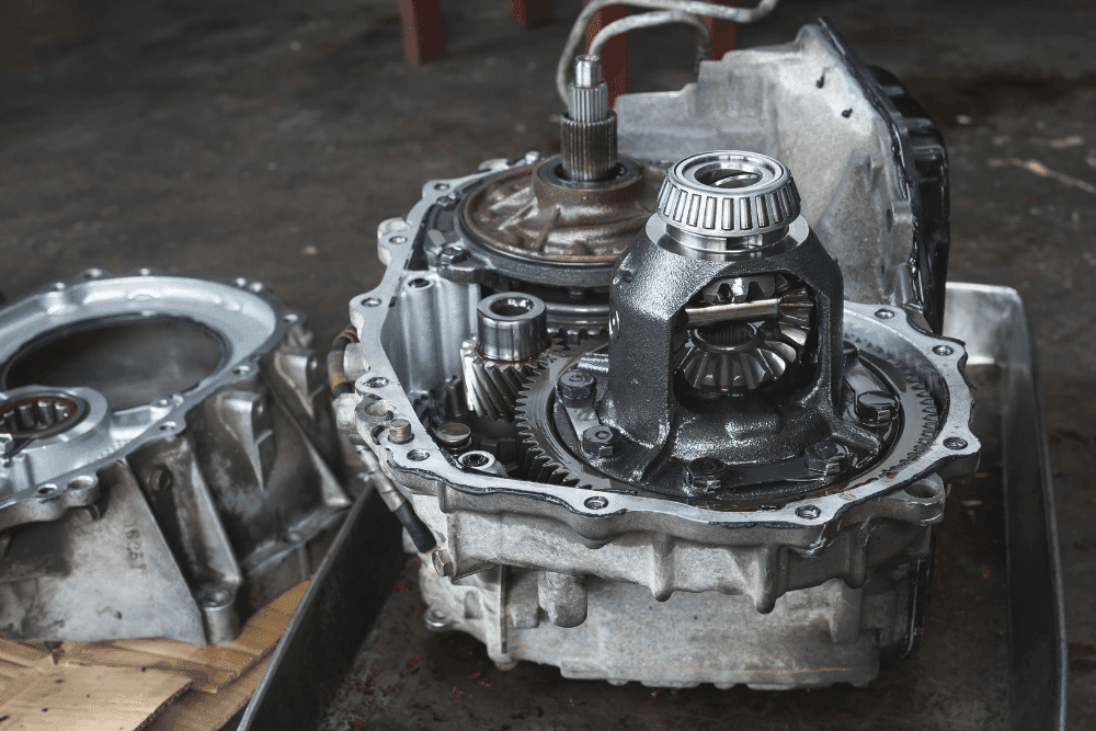 Differential and transfer case service, auto repair in Temecula, CA at Bobby Grich Auto Repair of Temecula. Image of an opened transmission housing with visible differential gears, bearings, and internal components during automotive service.